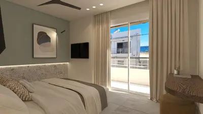 a bedroom with a bed and a large window at Eftihia Studios Paleochora in Palaiochóra