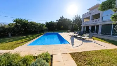 a swimming pool in the backyard of a house at MG Residence Boutique Holiday Home in Korakiaí