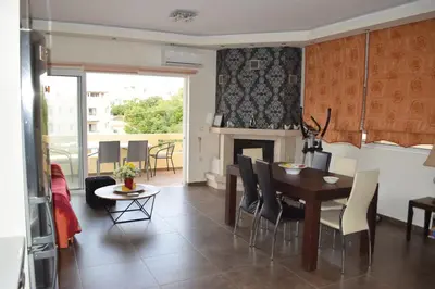 a kitchen and dining room with a table and a fireplace at Mary's modern apartment in Kissamos