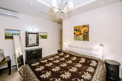 a bedroom with a bed and a chandelier at Mary's modern apartment in Kissamos