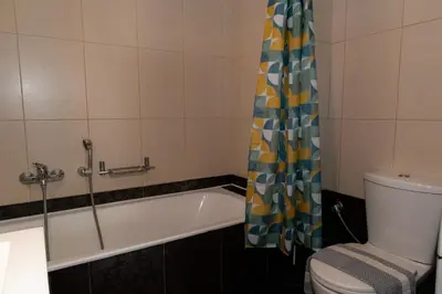 a bathroom with a tub and a toilet and a shower curtain at Maisonette in Koumpeli in Koumpeli