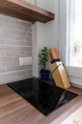 a room with a glass table with a potted plant at Central Kalyves Appartment - 5 min waking to the beach in Kalyves