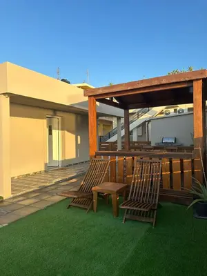 two chairs and a table on a patio at Villa Tile in Agia Marina Nea Kydonias