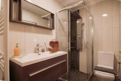 a bathroom with a sink and a shower and a toilet at Semeli House in Chania Town