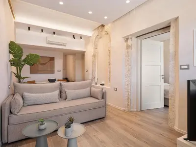 a living room with a couch and two tables at Venetian Harbour Residence in Chania Town