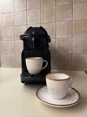 two cups on a plate next to a coffee maker at Venetian Harbour Residence in Chania Town