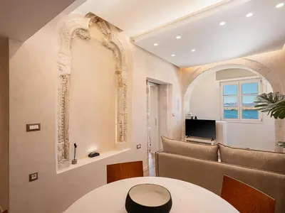 a living room with a table and a couch at Venetian Harbour Residence in Chania Town