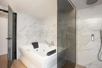 a bathroom with a white sink and a shower at Versante Rousso - Modern Living in Nature's Embrace by etouri in Káïna