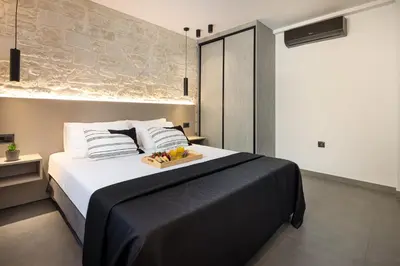 a bedroom with a bed with a tray of fruit on it at Luxurious Villas Rocca Blanco 1 & 2 in Kounoupidhianá