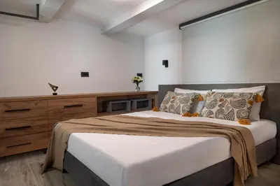 a bedroom with a large bed and a dresser at Luxurious Villas Rocca Blanco 1 & 2 in Kounoupidhianá