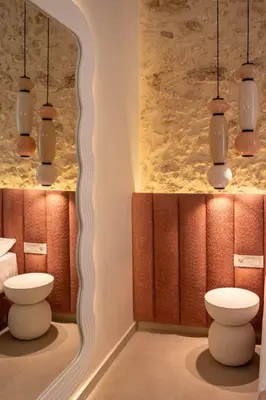 a bathroom with a toilet and a mirror at Madonna del Mare City in Chania Town