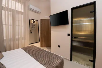 a bedroom with a bed and a flat screen tv at Madonna del Mare City in Chania Town