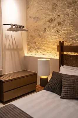 a bedroom with a bed and a lamp and a painting at Madonna del Mare City in Chania Town