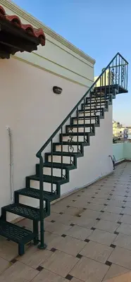 a staircase on the side of a building with a bench at Sea View appartment in Chania Town