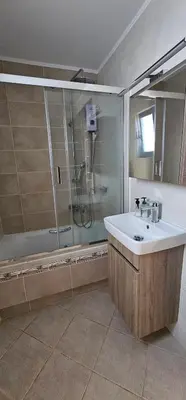 a bathroom with a shower and a sink at Sea View appartment in Chania Town