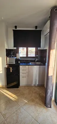 a kitchen with a sink and a stove top oven at Sea View appartment in Chania Town