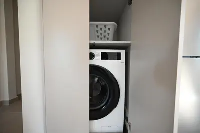 a washer and dryer in a white closet at Unick Avra Luxury Living in Kalathas