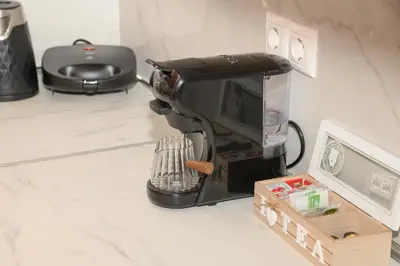 a coffee maker sitting on a counter next to a box at Happy House-Steps from Nea Chora Beach in Chania Town