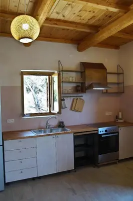 a kitchen with a sink and a stove at The Village Hideaway - Traditional Stone House in Kissamos