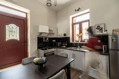 a kitchen with a table and a refrigerator at Casa Chris in Chania Town