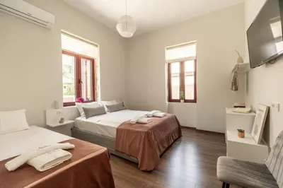 a white room with two beds and a couch at Casa Chris in Chania Town