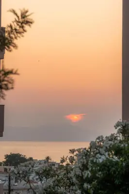 a sunset over the ocean with the sun in the sky at Casa Chris in Chania Town