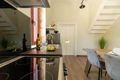 a kitchen and dining room with a table and chairs at Casa Chris in Chania Town