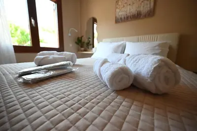 a bedroom with a bed with towels on it at Unick Seaview Luxury Living in Kalathas