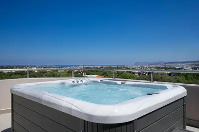 a hot tub on the roof of a building at Slavena Suite in Perivólia