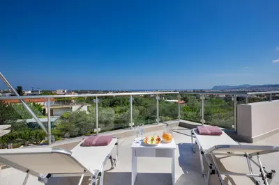 a balcony with a table and chairs and a view at Slavena Suite in Perivólia