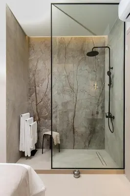 a shower with a glass door in a bathroom at Amfitriti Villa in Gramvousá