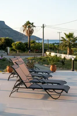 a row of benches lined up in a row at Amfitriti Villa in Gramvousá