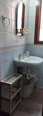 a bathroom with a sink and a mirror at Lili House in Chania Town