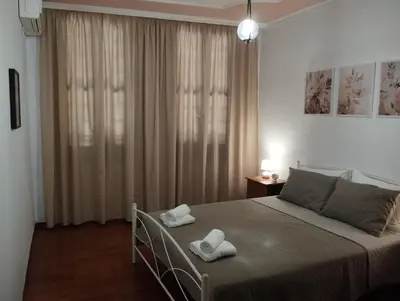 a bedroom with a bed with two towels on it at Lili House in Chania Town