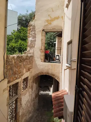 an external view of a stone building with a window at Lili House in Chania Town