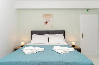 a bed with two white towels on top of it at Manoli's Studios Old Town Chania in Chania Town