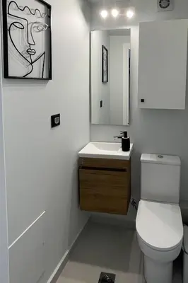 a bathroom with a toilet and a sink and a mirror at LOFTaki - Petite house next to Koum Kapi beach in Chania Town