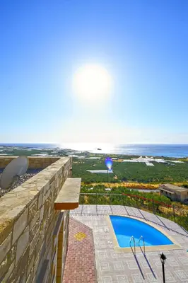 a view of the ocean from the balcony of a house at Fotini Traditional Villas in Kavoúsion