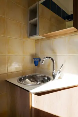 a kitchen sink with a blue cup next to it at Solena in Tsikalariá