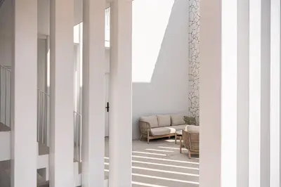 a living room with white walls and a couch at Nature & Beauty Villa in Xirostérnion