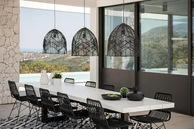 a dining room with a white table and chairs at Nature & Beauty Villa in Xirostérnion