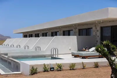 a house with a swimming pool in front of it at Mouria Luxury Suites - Adults Only in Falasarna