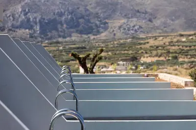 a bench with a view of a mountain at Mouria Luxury Suites - Adults Only in Falasarna