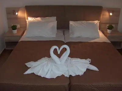 two swans made out of towels on a bed at Gerona Mare Apartments in Gerani Chanion