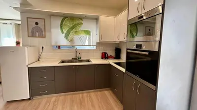 a kitchen with a sink and a stove top oven at Καλαίσθητο Ηλιόλουστο Studio in Chania Town