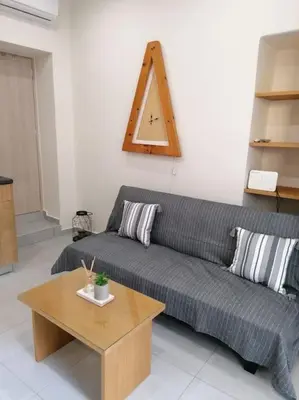 a living room with a couch and a table at Roidis Apartments -close to city in Chania Town