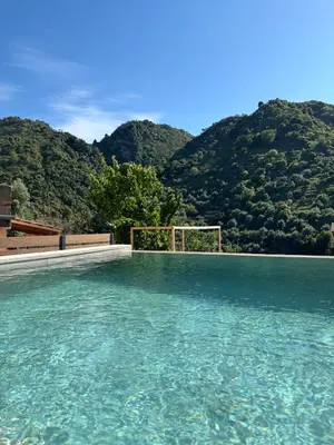a pool of water with mountains in the background at Nature dream 1833 in Dhrakóna
