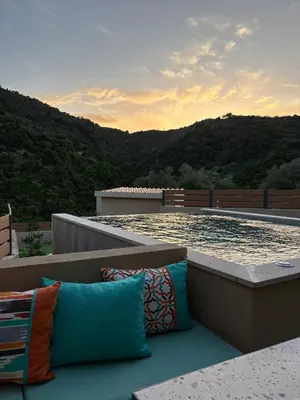 a swimming pool with pillows on top of a house at Nature dream 1833 in Dhrakóna