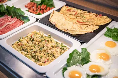 a buffet of food with eggs and meats at Elia Agia Marina Hotel in Agia Marina Nea Kydonias