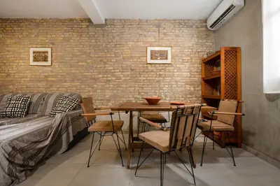 a room with a table and chairs and a brick wall at Rianou Apartment in Chania Town